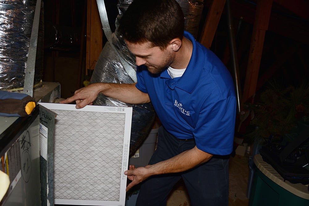 Technician checking air filters as part of Bart's HVAC Heating Service DFW