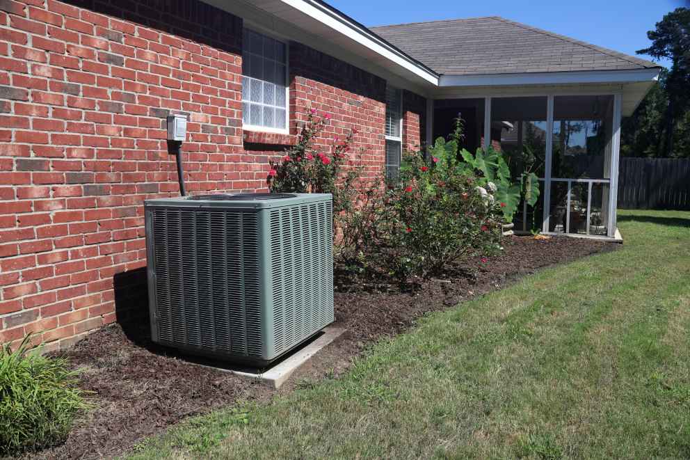 Air conditioner unit next to a residential home.