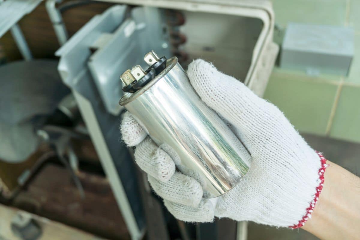 Technician with an AC capacitor